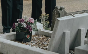 A gravestone and flowers