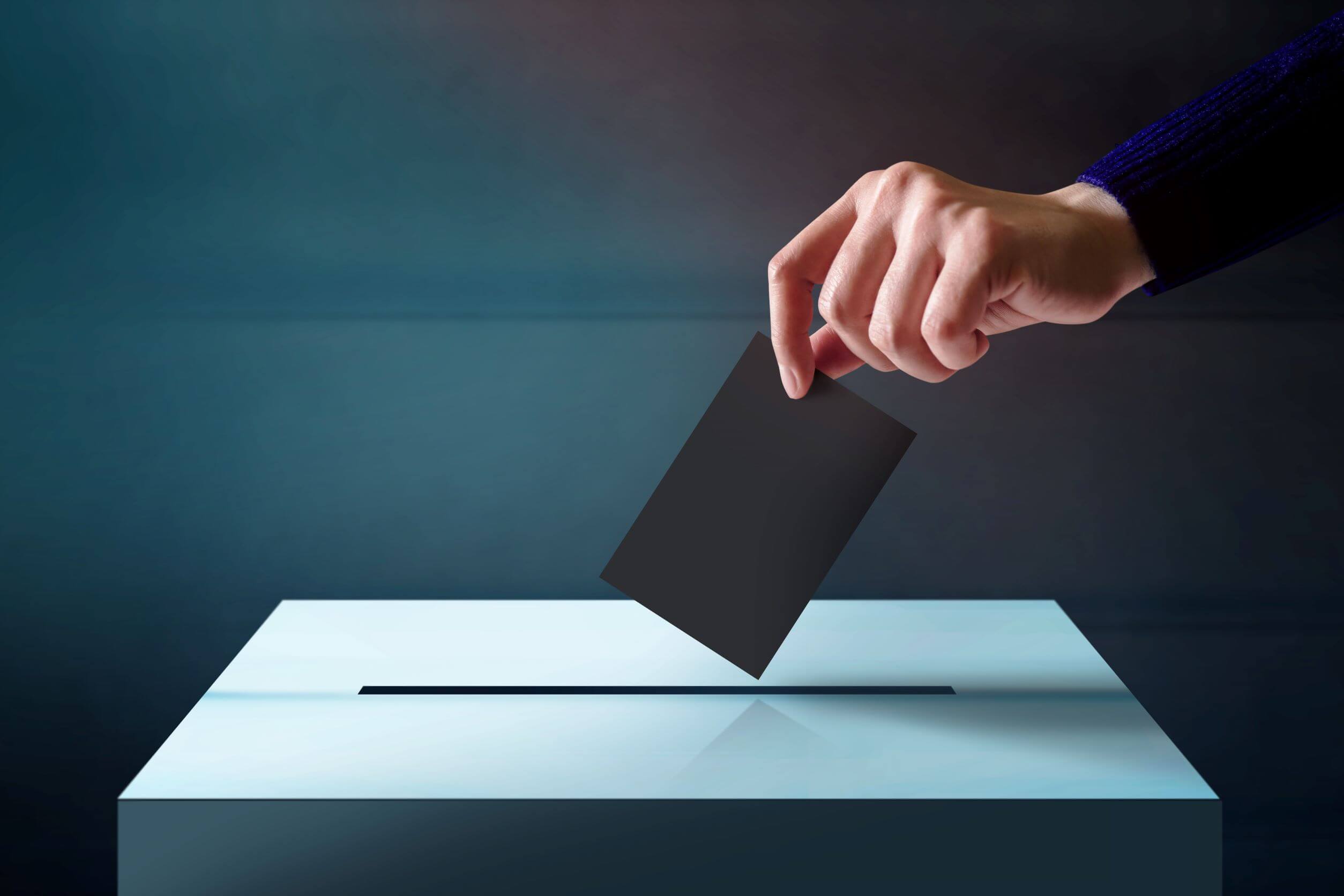 Person placing vote in ballot box