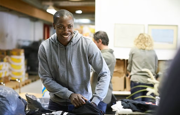 A gentleman organising clothes for an event