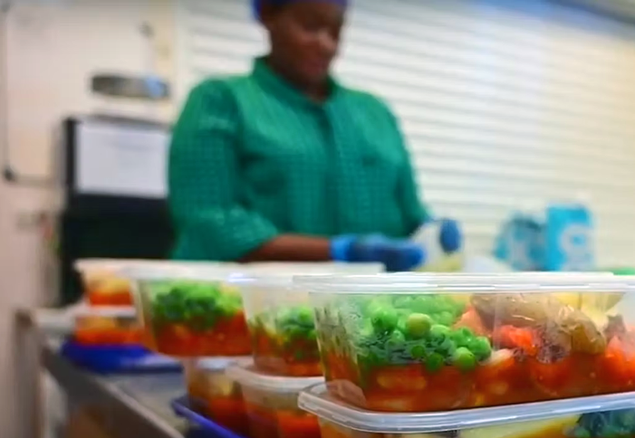 A volunteer packing up meals for people who need them