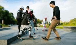 A young skateboarder being tutored